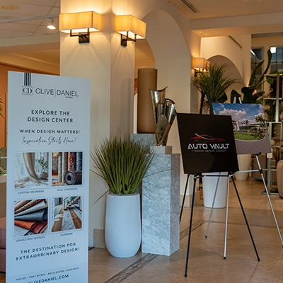 Entrance display featuring Clive Daniel Design and Auto Vault Naples signage.