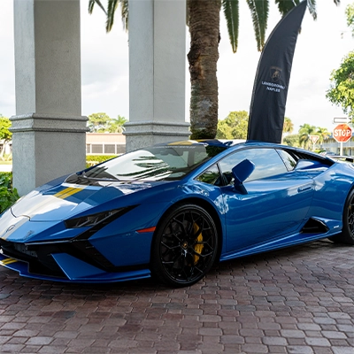 Blue Lamborghini showcased at the Auto Vault Naples luxury event