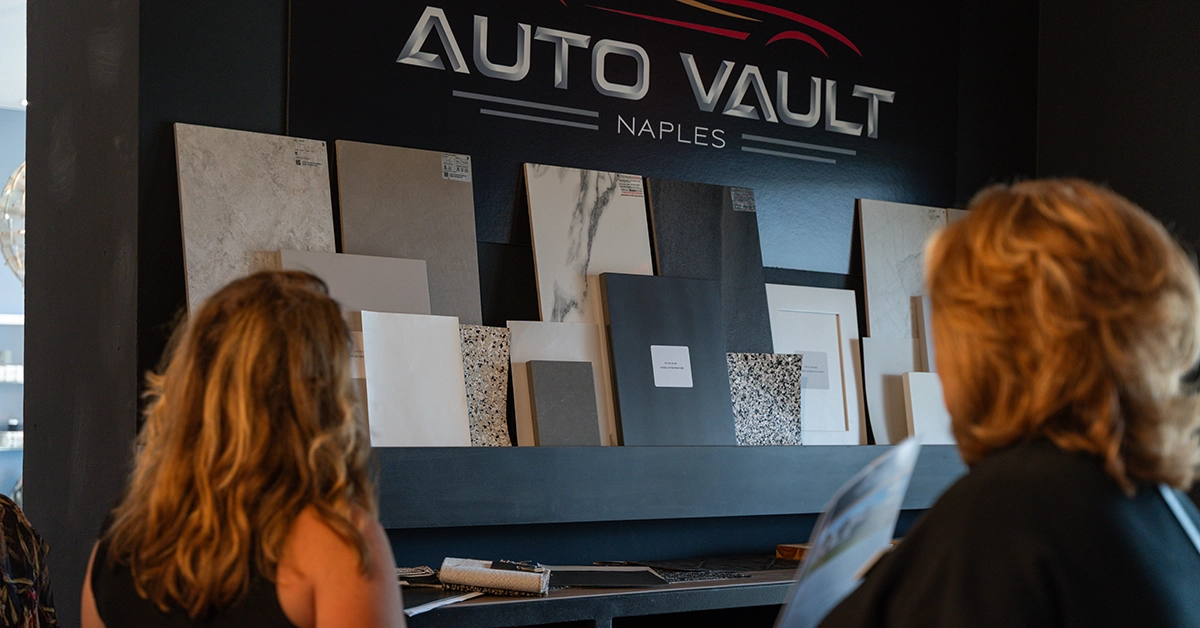 Buyers reviewing customization options at Naples Auto Vault during pre-construction.